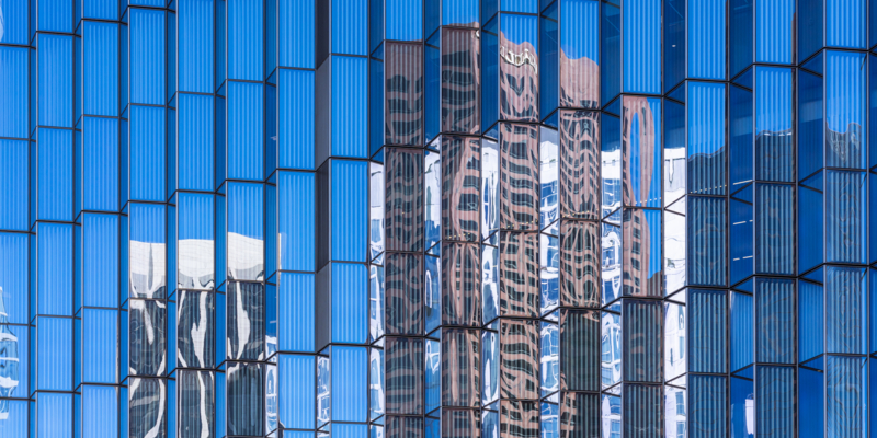 This view from Hill Street in downtown Los Angeles features reflections on the glass facade of the the First Street U.S. Courthouse.