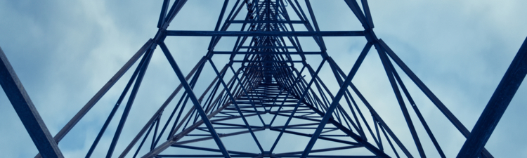 Looking directly up the middle of a communications tower.