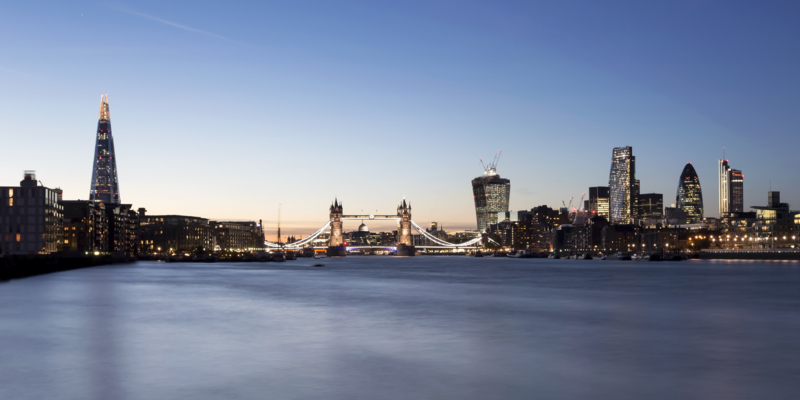 View of London's skyline with The Shard, Tower Bridge and City of London at dusk.