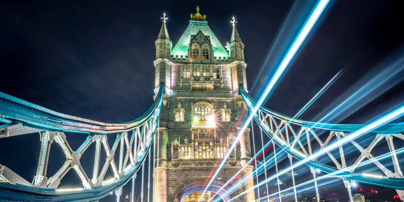 Colourful light trail created by the busy traffic on Tower Bridge, London.
