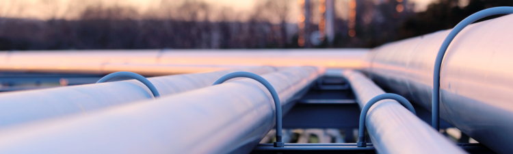 steel long pipe system in crude oil factory during sunset