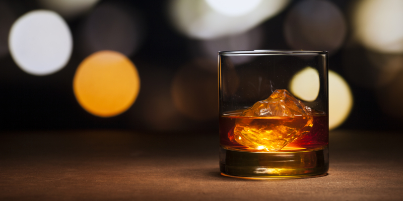 Photography of a glass whisky with ice.
