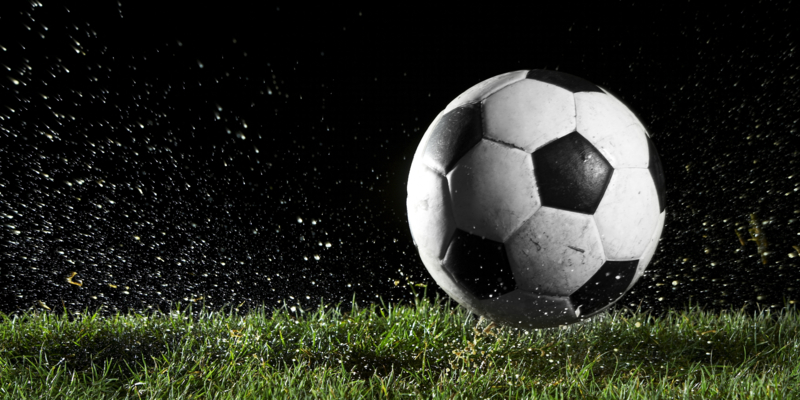 Soccer ball in motion over grass